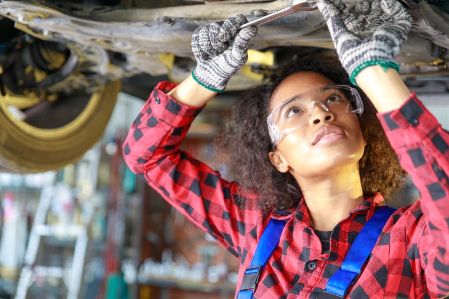 Female auto mechanic working at the repair shop