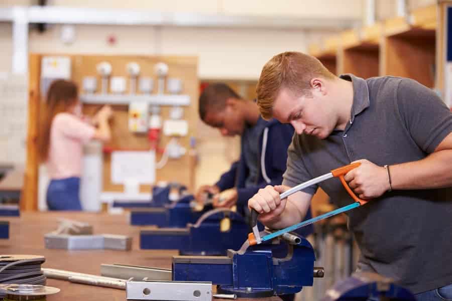 Students using saws in electrician training class