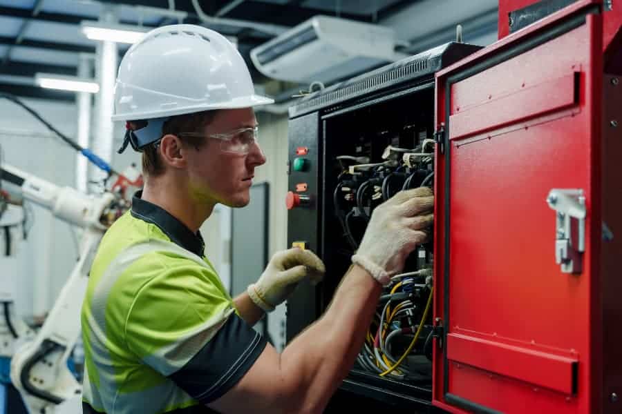 Engineer performing electrical inspection on control box