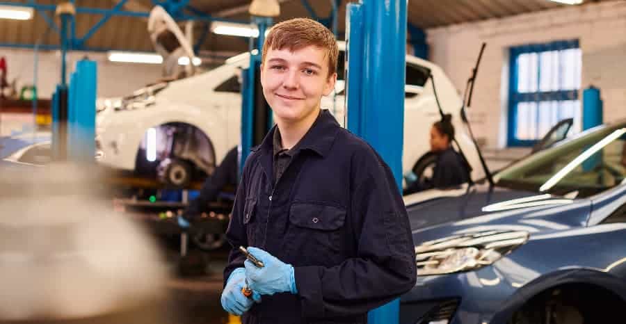 Car mechanic apprentice in workshop